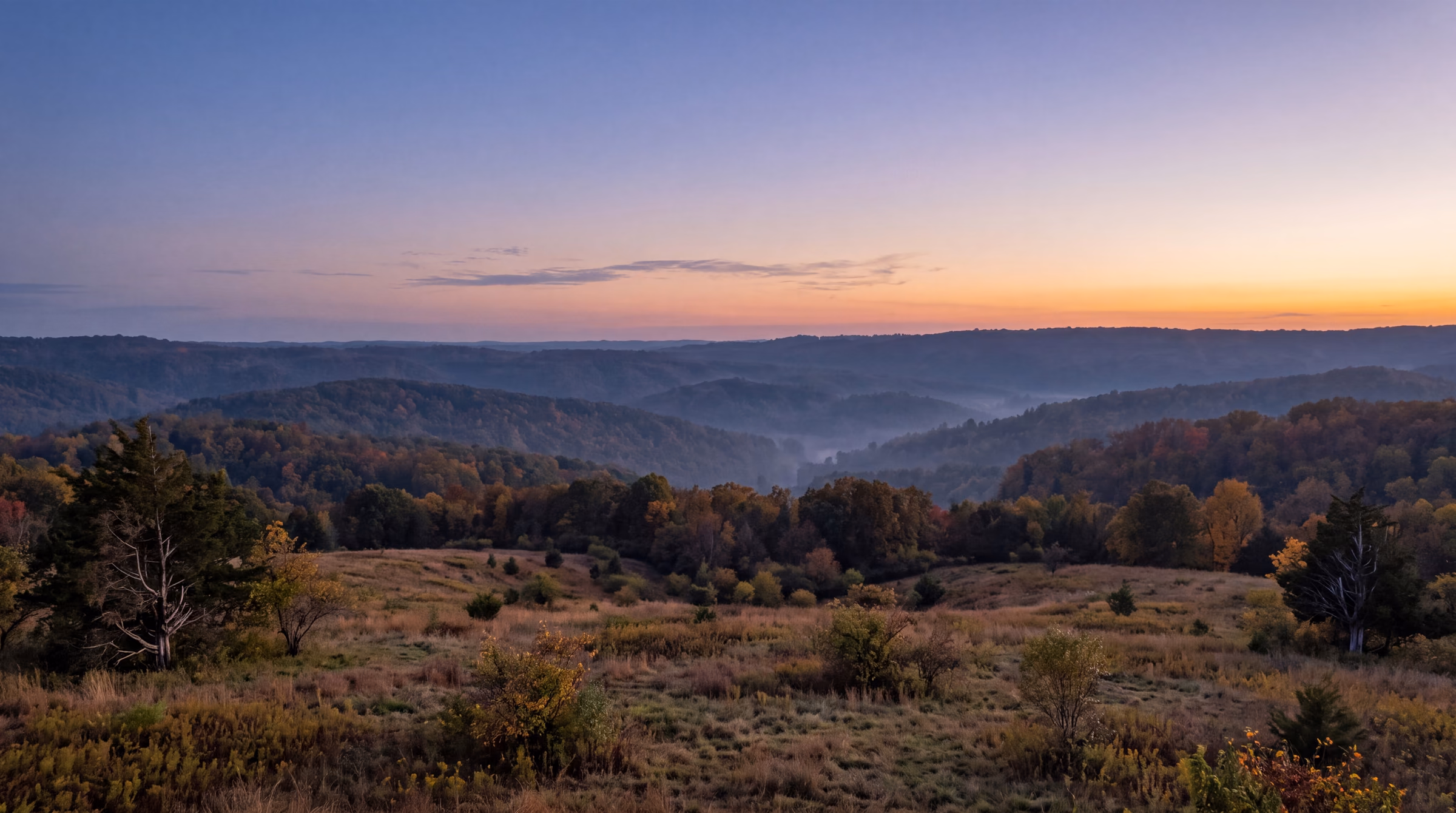 Evening sky over layered Ozark ridges